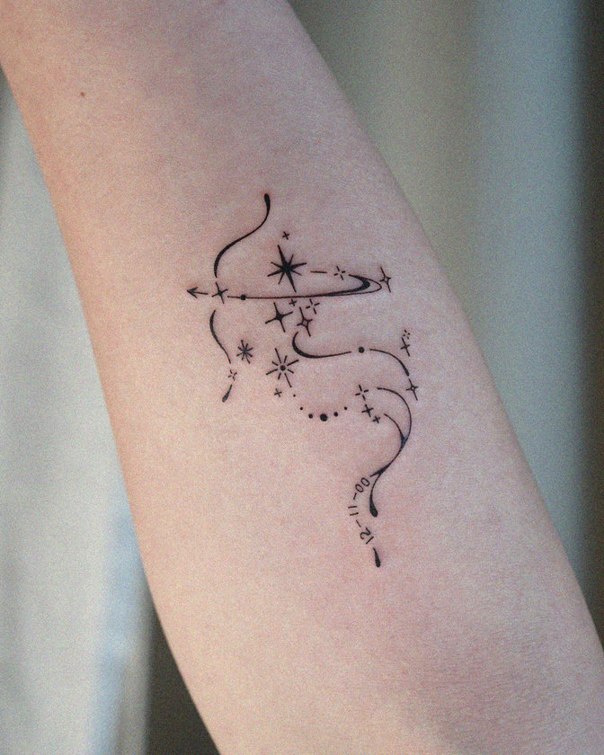 Celestial Arrow Tattoo Adorns Forearm