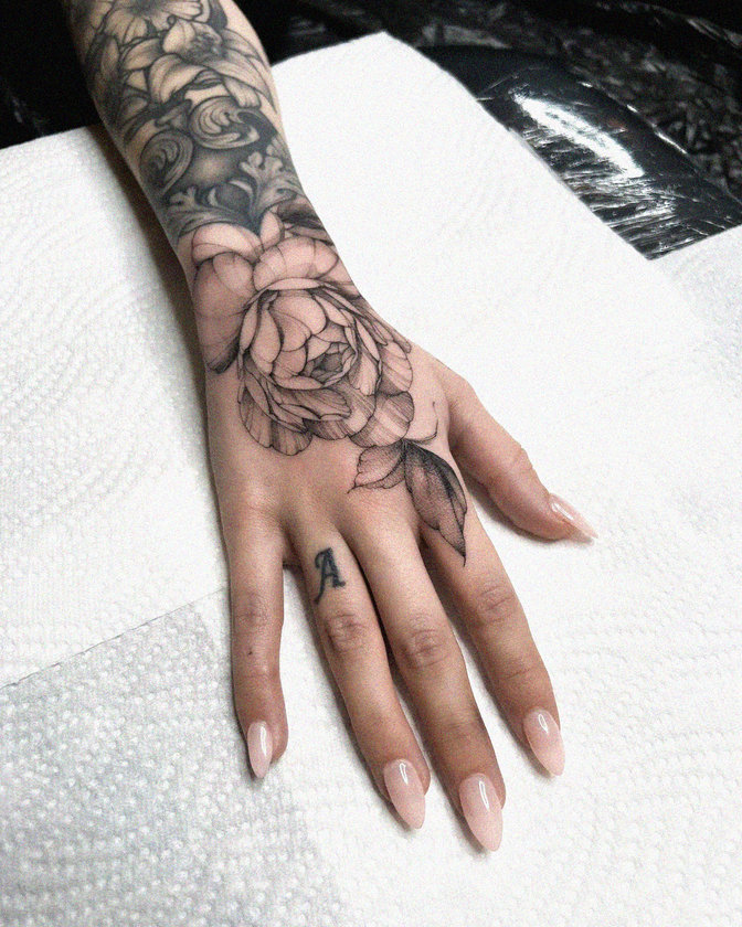 Hand Adorned with Floral Ink Artistry