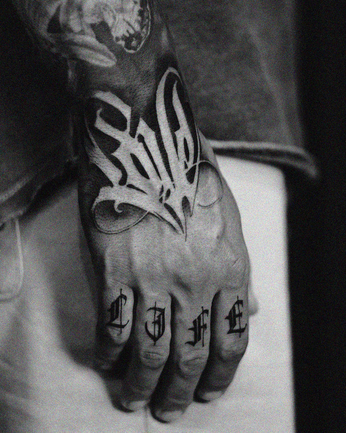 Butterfly Whispers on Inked Fingers
