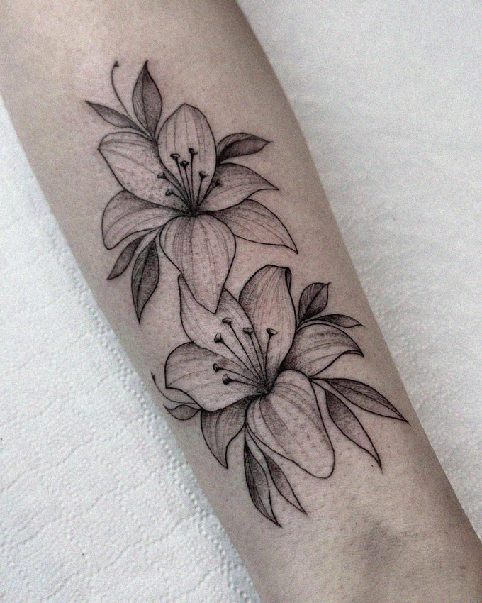 Inked Lilies Adorning a Forearm